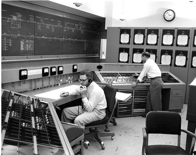 Two men working in large control room (1960s)